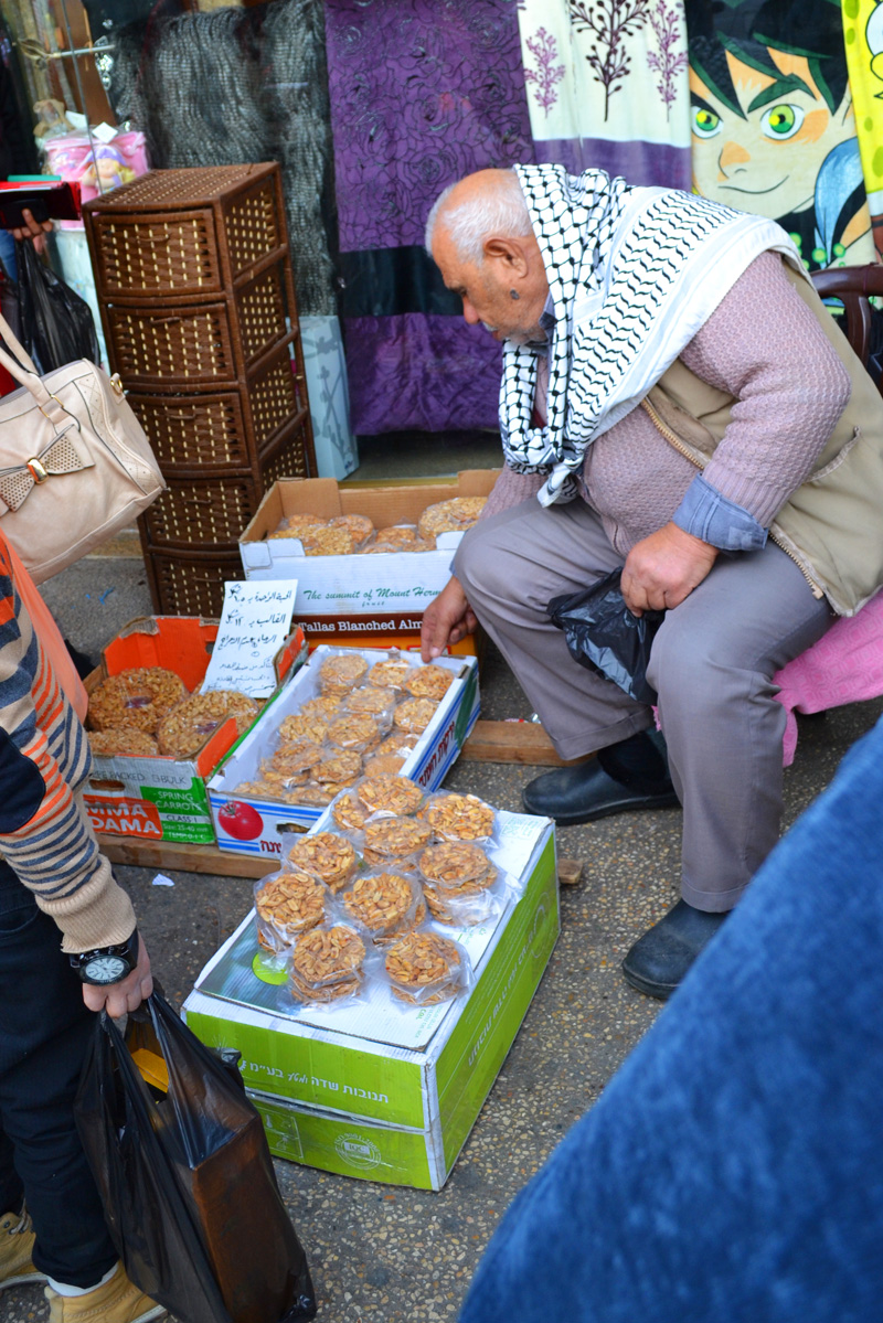 An old man selling sesame brittle  on the streets of Nablus