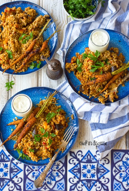 Middle eastern eggplant bulgur pilaf. Creamy eggplant, warm spices and earthy nutty bulgur served with garlic sumac baby carrots and greek yogurt. A true feast for the taste buds